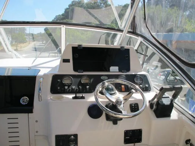 Slide: The Image of 2005 Grady-White 282 Sailfish helm with steering wheel and instrument panel. - 5