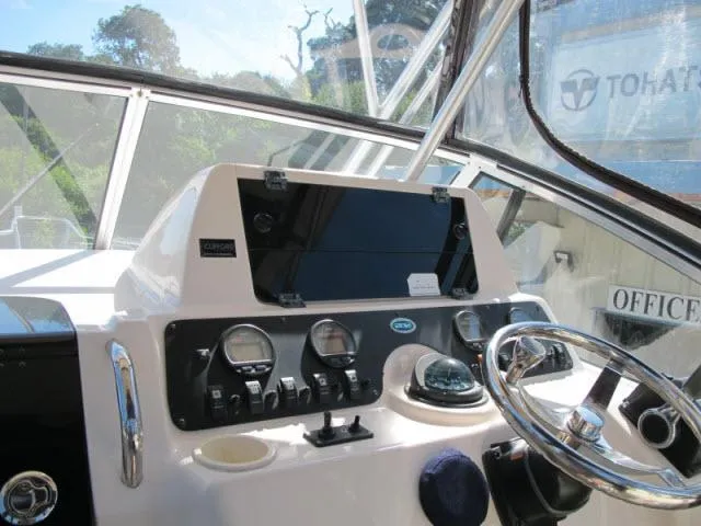 Slide: The Image of 2005 Grady-White 282 Sailfish boat dashboard with steering wheel and navigation instruments. - 6