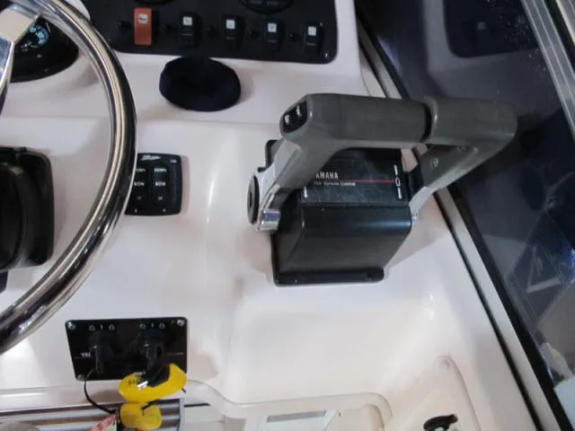 Slide: The Image of Control panel of 2005 Grady-White 282 Sailfish boat with steering wheel and throttle. - 8