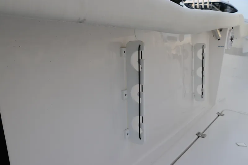 Slide: The Image of 2024 Tidewater 256 LXF boat detail, featuring sleek white exterior and hardware. - 12