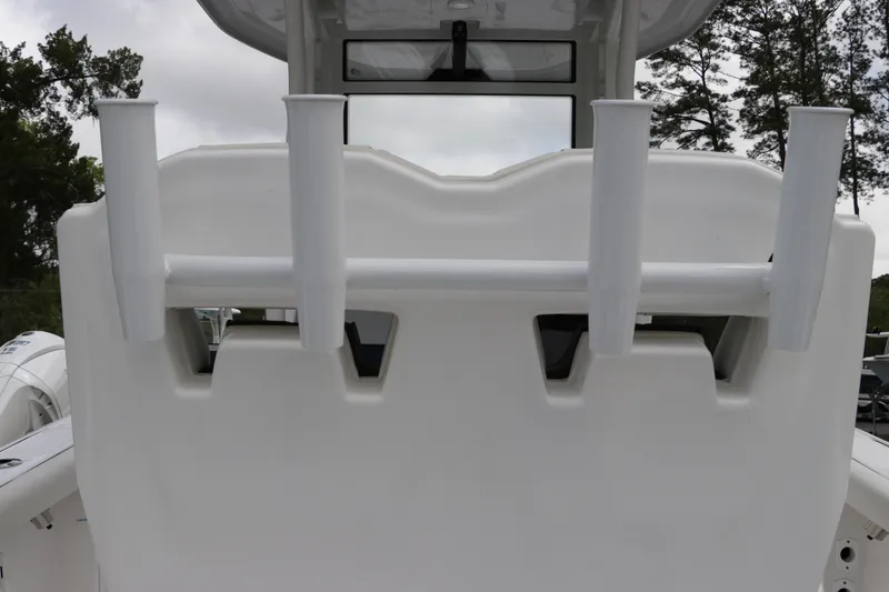 Slide: The Image of 2024 Tidewater 256 LXF boat with rod holders and sleek white design. - 14