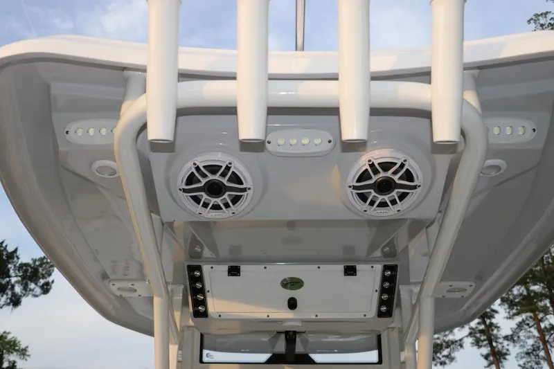 Slide: The Image of 2024 Tidewater 256 LXF boat speakers and rod holders on T-top. - 15