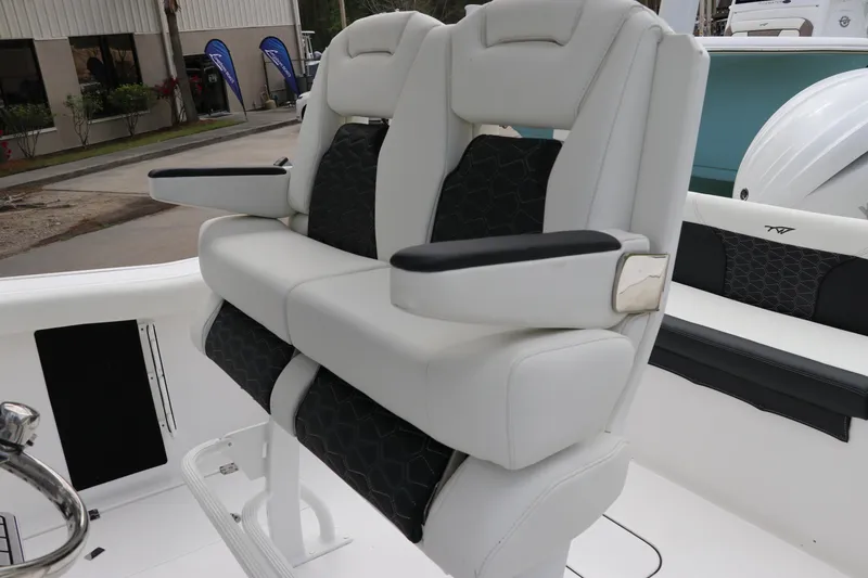 Slide: The Image of 2024 Tidewater 256 LXF boat with luxurious white and black seating at the helm. - 18