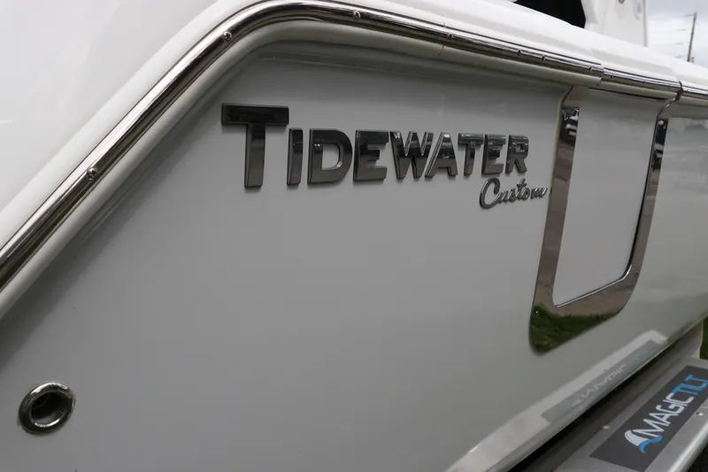 Slide: The Image of 2024 Tidewater 256 LXF boat with custom branding on the side. - 2