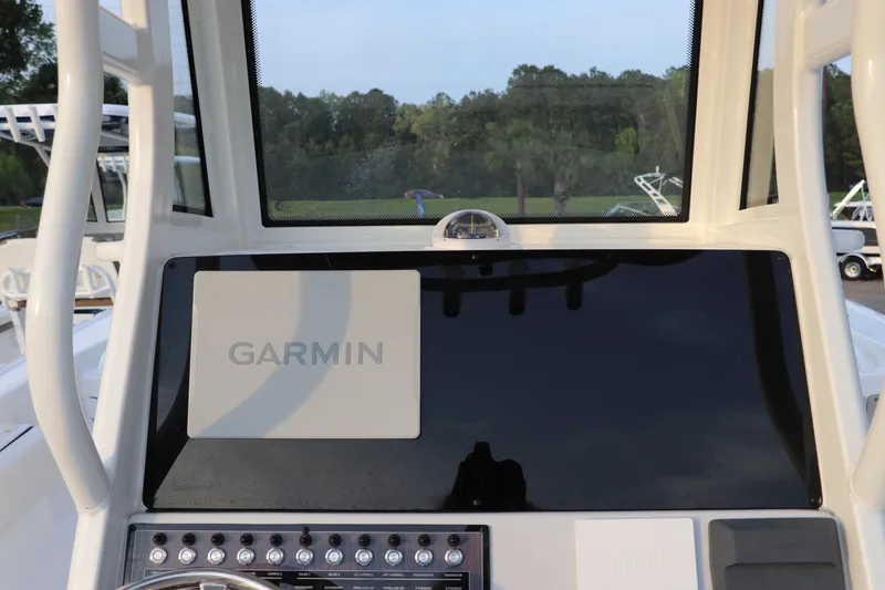 Slide: The Image of 2024 Tidewater 256 LXF boat dashboard with Garmin navigation system. - 24
