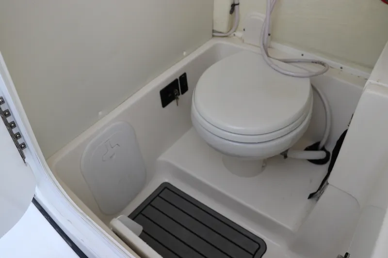 Slide: The Image of 2024 Tidewater 256 LXF boat interior bathroom with toilet and flooring. - 28