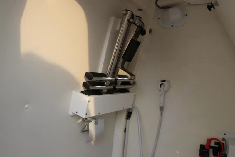 Slide: The Image of 2024 Tidewater 256 LXF boat interior with mounted rod holders and equipment. - 29