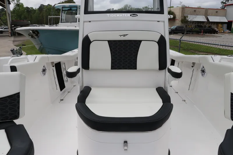 Slide: The Image of 2024 Tidewater 256 LXF boat interior with cushioned seating and modern design. - 30