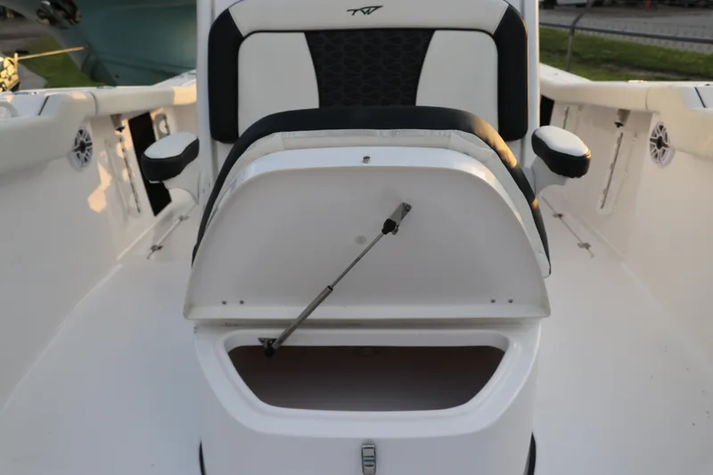 Slide: The Image of 2024 Tidewater 256 LXF boat seat with storage compartment open. - 32