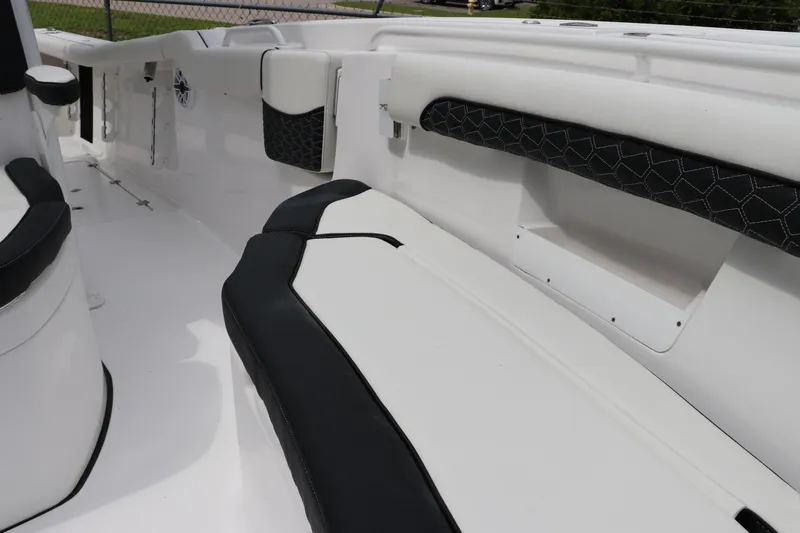 Slide: The Image of 2024 Tidewater 256 LXF boat interior with sleek black and white seating design. - 34