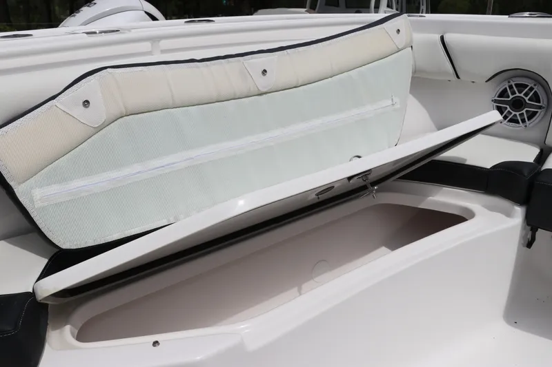 Slide: The Image of 2024 Tidewater 256 LXF boat storage compartment with open cushioned seat. - 37