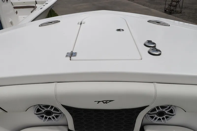 Slide: The Image of 2024 Tidewater 256 LXF boat deck with storage hatch and speakers. - 43