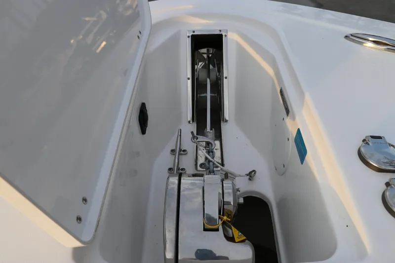 Slide: The Image of 2024 Tidewater 256 LXF boat anchor compartment with open hatch. - 44