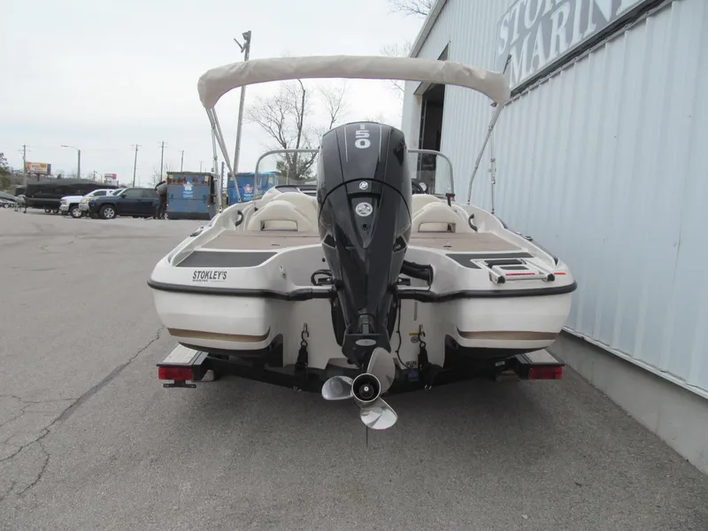 Slide: The Image of 2012 Nitro Z-7 Sport boat with outboard motor, parked near a marina. - 3
