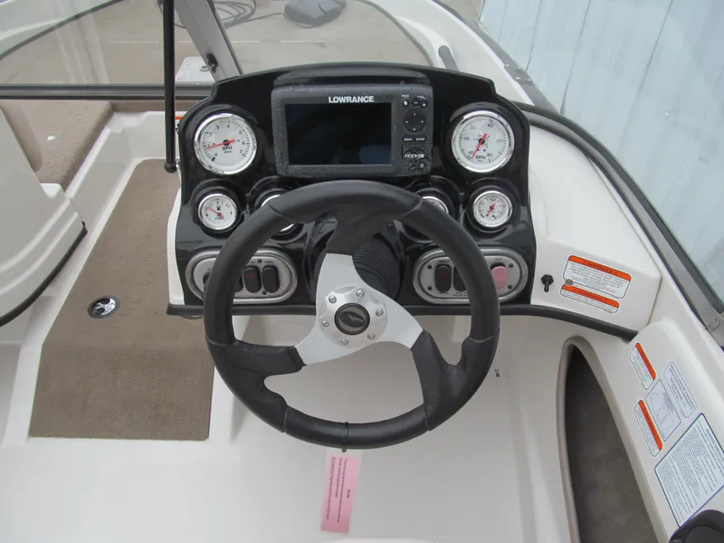 Slide: The Image of 2012 Nitro Z-7 Sport boat dashboard with steering wheel and gauges. - 5
