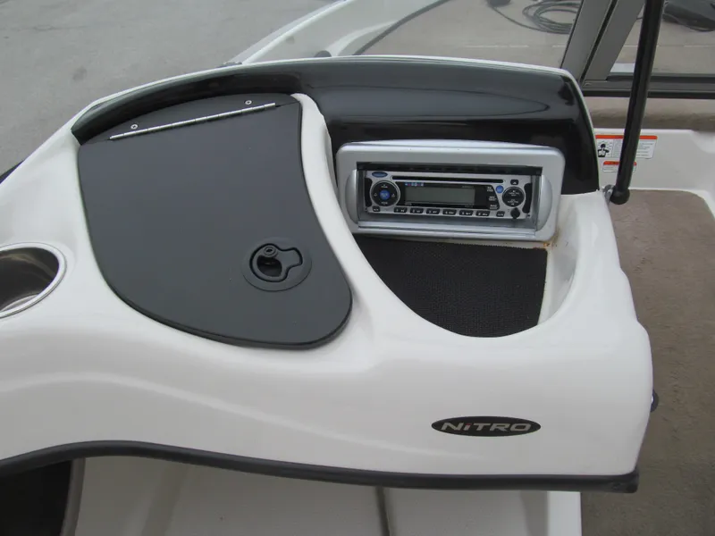 Slide: The Image of 2012 Nitro Z-7 Sport boat dashboard with stereo system and storage compartment. - 6