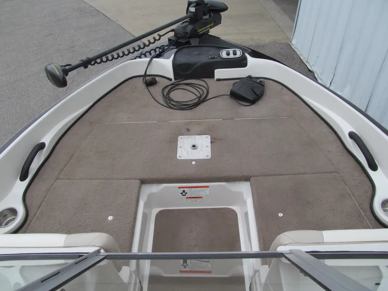 Slide: The Image of 2012 Nitro Z-7 Sport boat deck with trolling motor and carpeted surface. - 7