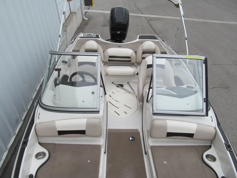 Slide: The Image of 2012 Nitro Z-7 Sport boat interior with beige seating and dual consoles. - 8