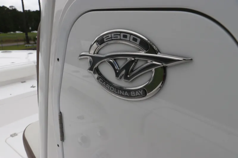 Slide: The Image of 2024 Tidewater 2500 Carolina Bay logo on white boat exterior. - 13