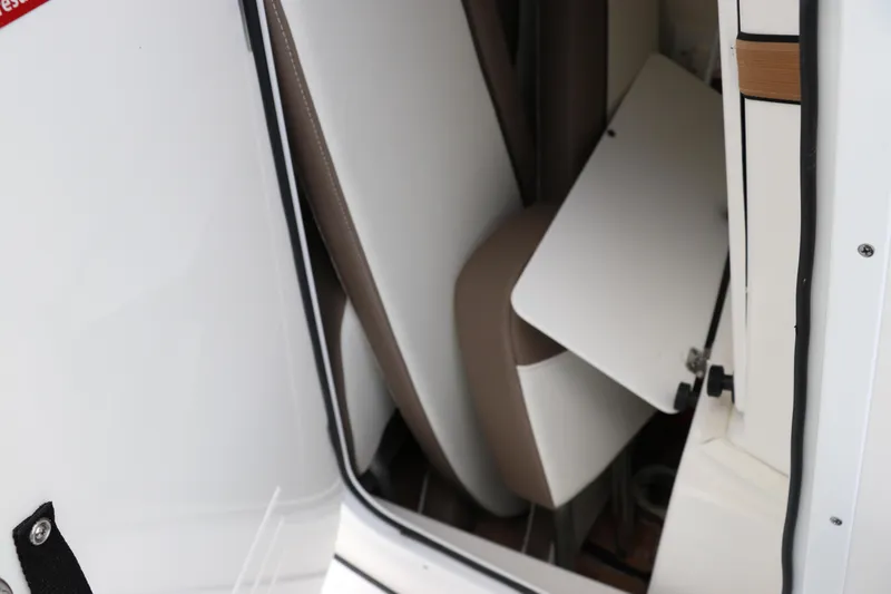 Slide: The Image of 2024 Tidewater 2500 Carolina Bay interior seating detail with white and brown upholstery. - 14