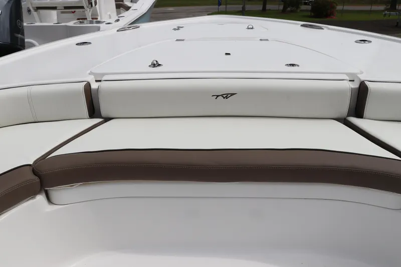 Slide: The Image of 2024 Tidewater 2500 Carolina Bay boat interior with cushioned seating and sleek design. - 18
