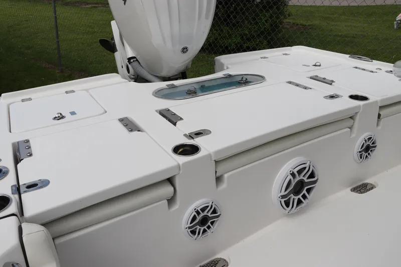 Slide: The Image of 2024 Tidewater 2500 Carolina Bay boat deck with storage compartments and speakers. - 2