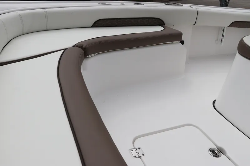 Slide: The Image of 2024 Tidewater 2500 Carolina Bay boat interior with cushioned seating and storage compartments. - 20