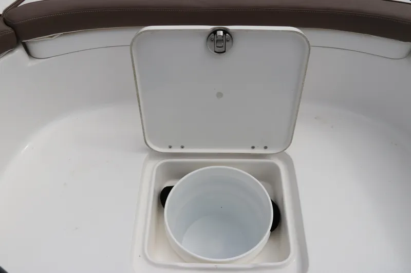 Slide: The Image of 2024 Tidewater 2500 Carolina Bay boat storage compartment with open hatch and bucket. - 22