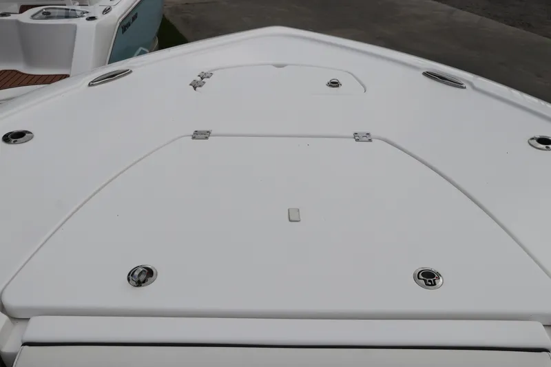 Slide: The Image of 2024 Tidewater 2500 Carolina Bay boat deck, featuring sleek design and storage compartments. - 24