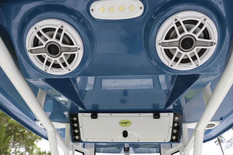 Slide: The Image of 2024 Tidewater 2500 Carolina Bay boat speakers and lighting on blue interior ceiling. - 8
