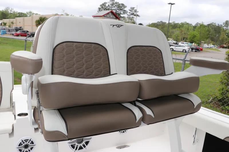 Slide: The Image of 2024 Tidewater 2500 Carolina Bay boat seats with brown and white upholstery, featuring diamond stitching. - 9