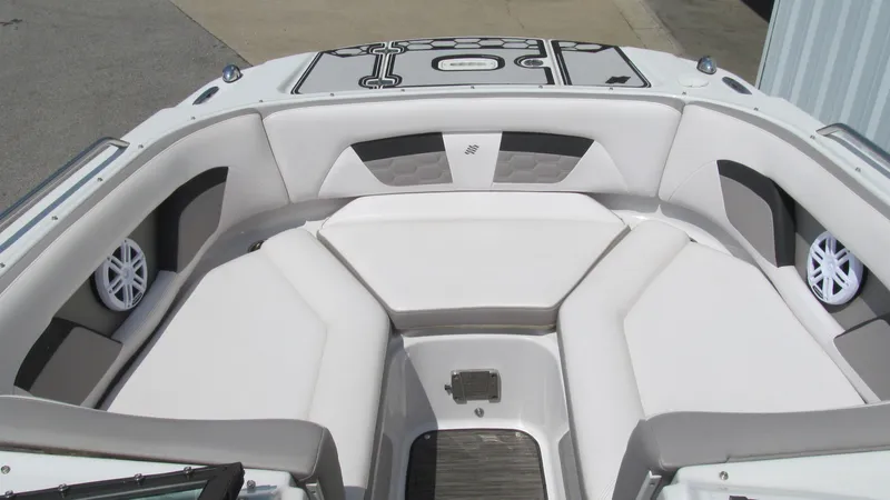 Slide: The Image of 2017 Four Winns HD220 boat interior with white cushioned seating and speaker system. - 10