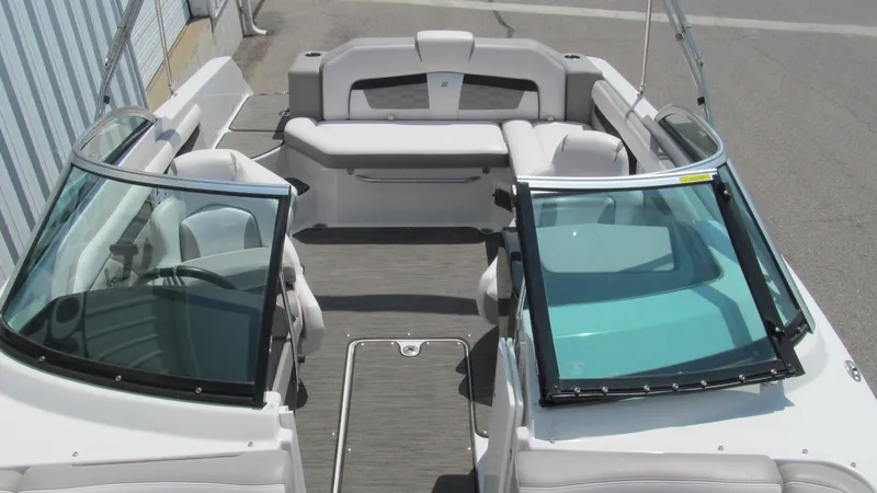 Slide: The Image of 2017 Four Winns HD220 boat interior with spacious seating and dual windshields. - 12