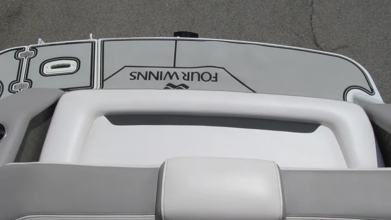 Slide: The Image of 2017 Four Winns HD220 boat interior with logo, featuring sleek gray and white design. - 14