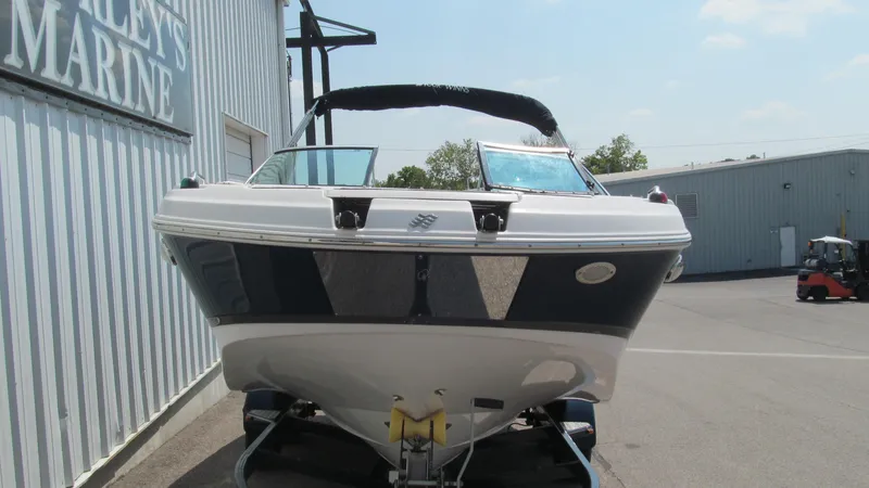 Slide: The Image of 2017 Four Winns HD220 boat on trailer at a marina. - 3