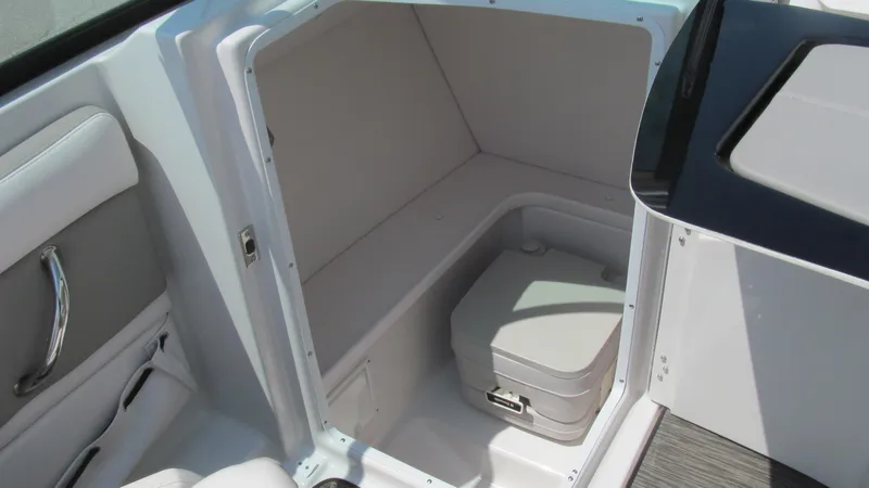 Slide: The Image of 2017 Four Winns HD220 boat interior with compact toilet compartment. - 8