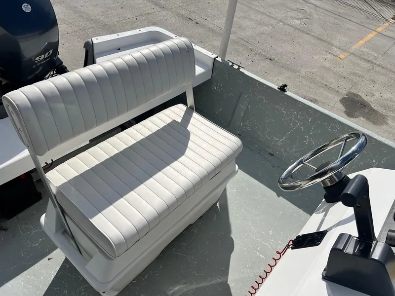 Slide: The Image of White boat interior with steering wheel and Yamaha 90 engine, Frontier F-18, 2013 model. - 11