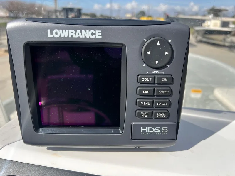 Slide: The Image of Lowrance HDS-5 marine GPS device with control buttons, displayed outdoors. - 12