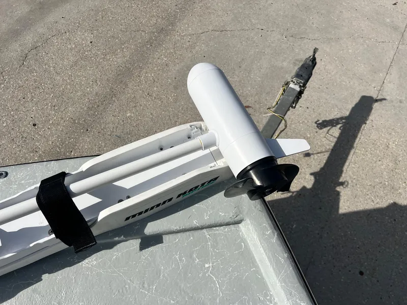 Slide: The Image of Boat motor mounted on a Frontier F-18, 2013 model, on a concrete surface. - 14