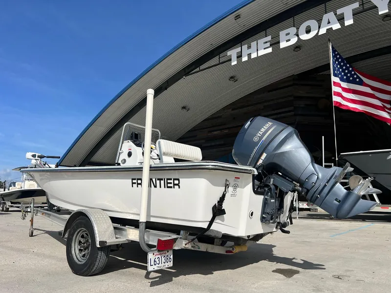 Slide: The Image of 2013 Frontier F-18 boat with Yamaha motor at The Boat Yard, American flag visible. - 3
