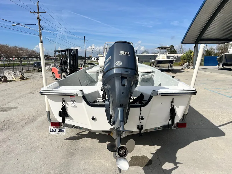 Slide: The Image of 2013 Frontier F-18 boat with Yamaha 90 outboard motor in a marina setting. - 5