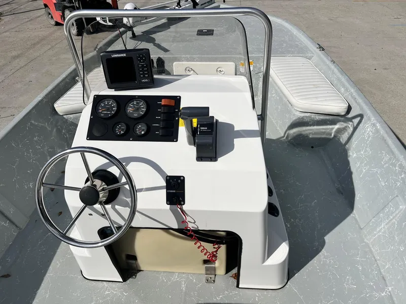 Slide: The Image of 2013 Frontier F-18 boat console with steering wheel, gauges, and navigation system. - 6