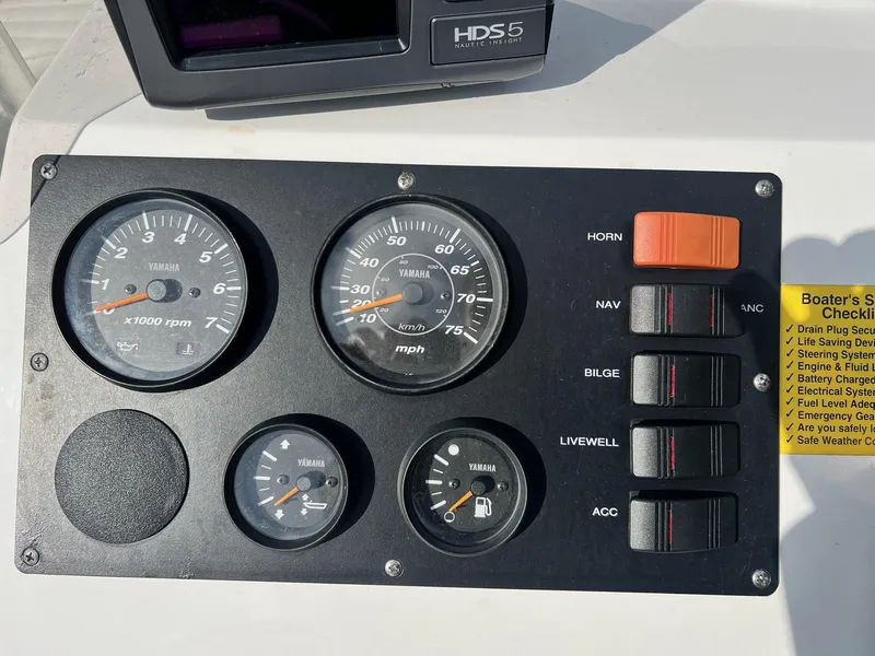Slide: The Image of Control panel of a 2013 Frontier F-18 boat with Yamaha gauges and switches. - 7