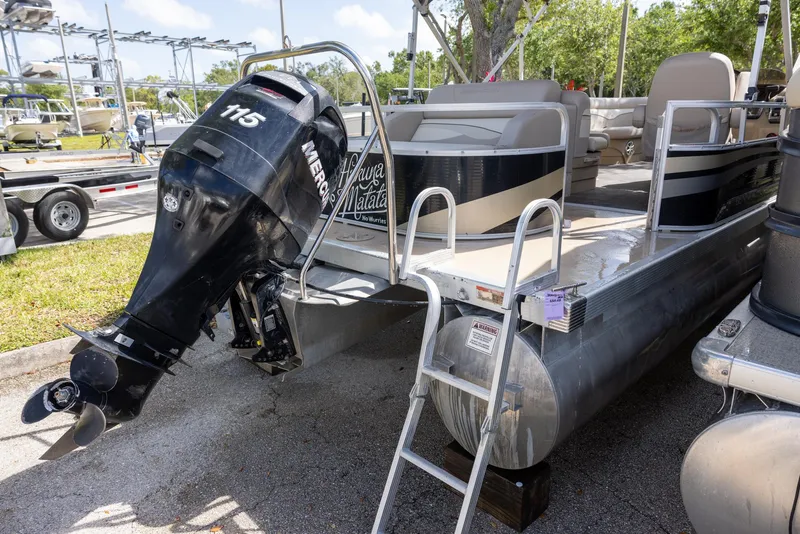 Slide: The Image of 2012 Bennington 22 SSL pontoon boat with Mercury 115 outboard motor, docked outdoors. - 1