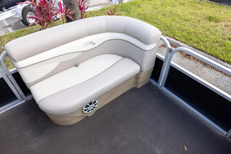 Slide: The Image of 2012 Bennington 22 SSL boat interior with beige seating and speaker. - 10
