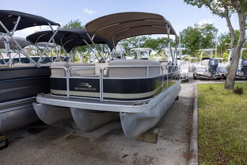 Slide: The Image of 2012 Bennington 22 SSL pontoon boat with canopy, parked on a lot. - 3