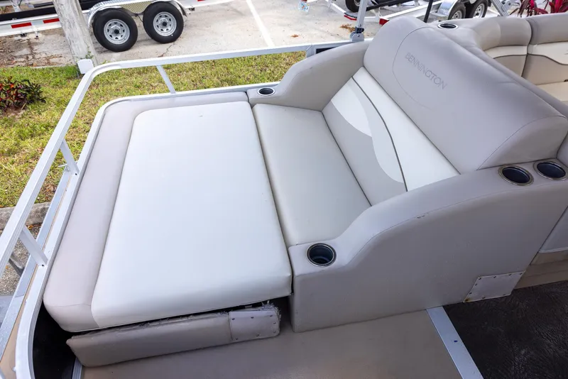 Slide: The Image of 2012 Bennington 22 SSL boat seat with beige upholstery and cup holders. - 5