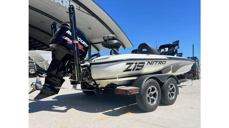 Slide: The Image of 2017 Nitro Z19 boat with Mercury engine on trailer, parked outdoors. - 3