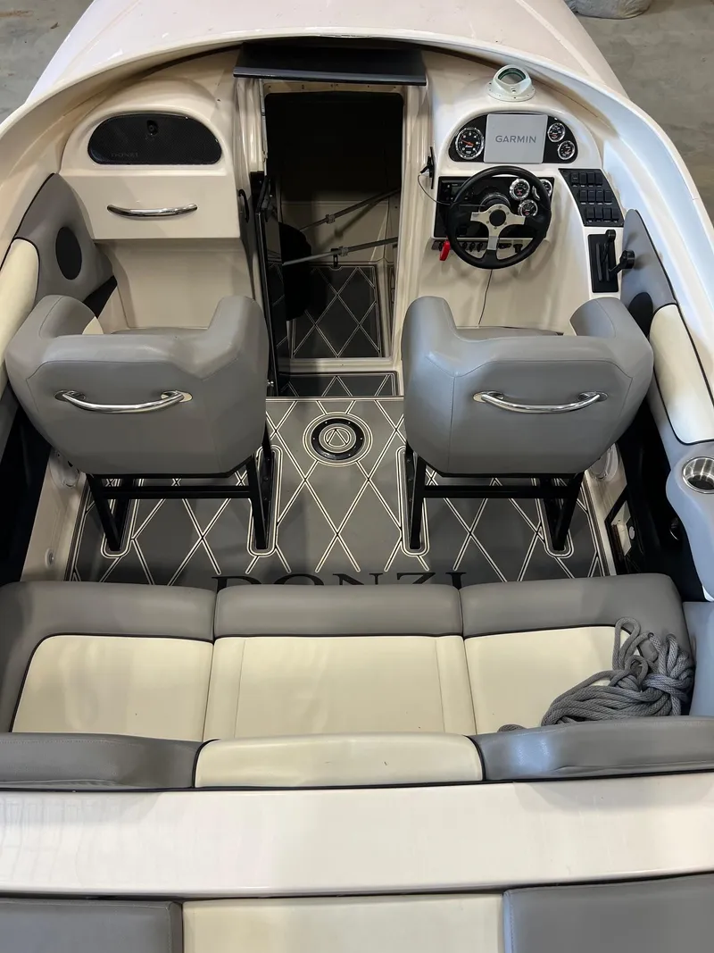 Slide: The Image of 1997 Donzi 27 ZX boat interior with gray and white seating, modern dashboard, and stylish flooring. - 10