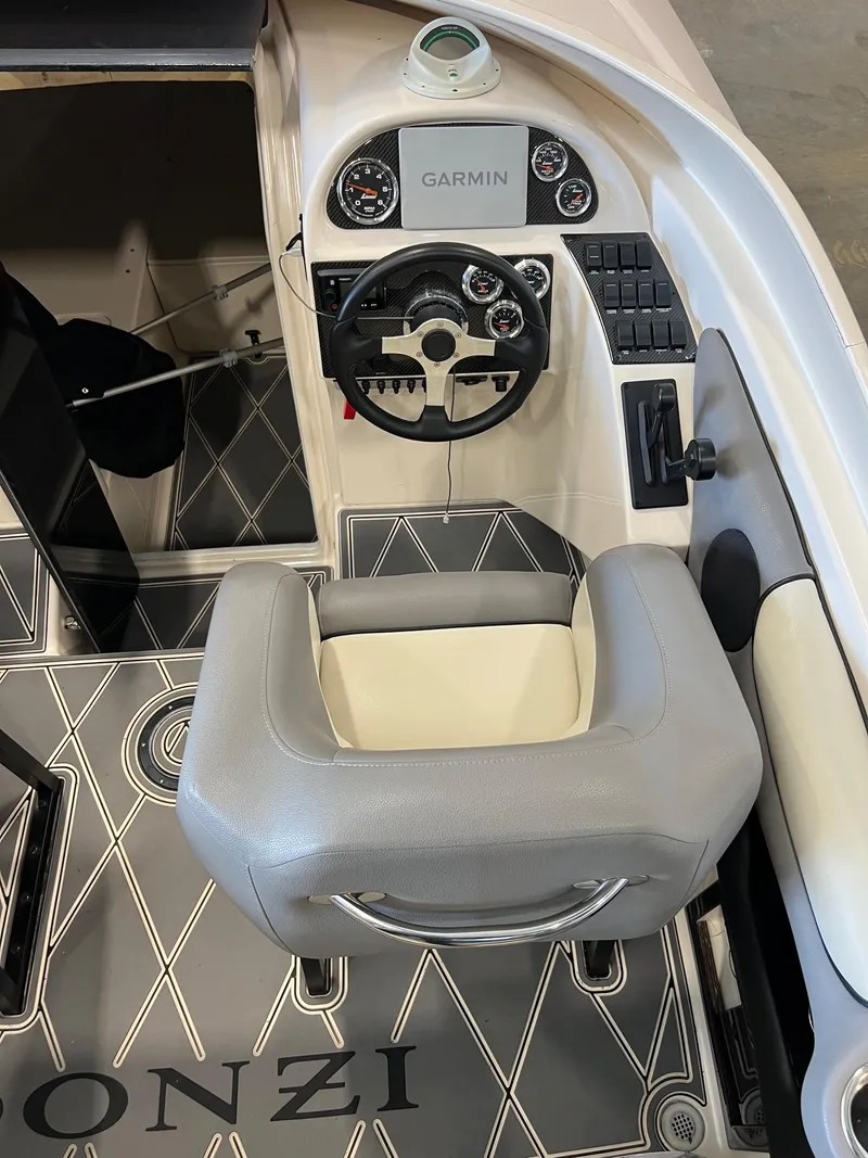 Slide: The Image of 1997 Donzi 27 ZX boat interior with Garmin navigation and stylish seating. - 11